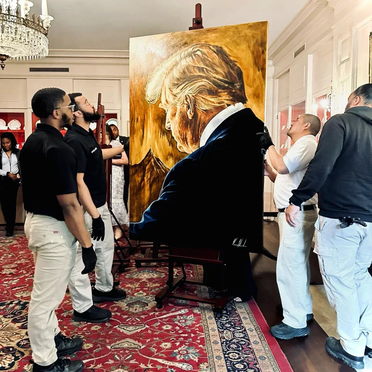 The White House handlers unpacking Vanessa Horabuena's original painting "Prayers for Our President - For Such a Time as This"